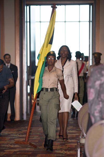 Ms. Carolyn Lewis, Director of Audit, Jamaica enters during the procession of  national flags.